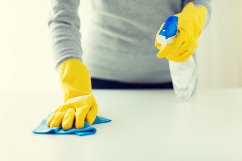 Cleaner using safe manual handling techniques with equipment